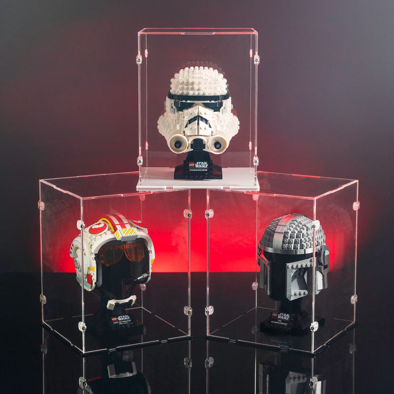 Three Star Wars lego themed helmets in clear acrylic cases with red glow light