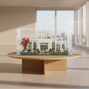 Toy Model of a greenhouse on a table in a room with large windows