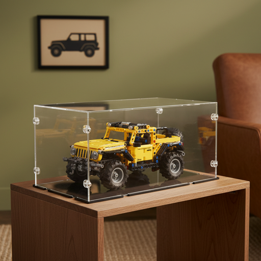 lego jeep wrangler in yellow in a clear display case on a wooden table with a green wall and framed picture in the background.