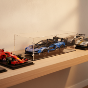 blue model mclaren car on a wooden shelf in a clear display case dust-proof, uv protected