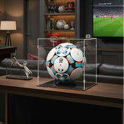 lego soccer ball in a display case in a living room with a TV displaying a soccer match.