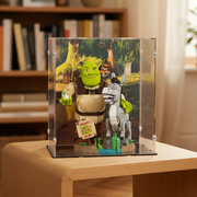 Shrek and Donkey lego figurines in a custom display case on a wooden table.