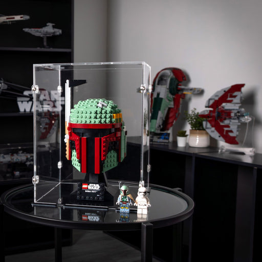 LEGO Boba Fett figure in a clear display case on a table with Star Wars-themed decorations in the background.