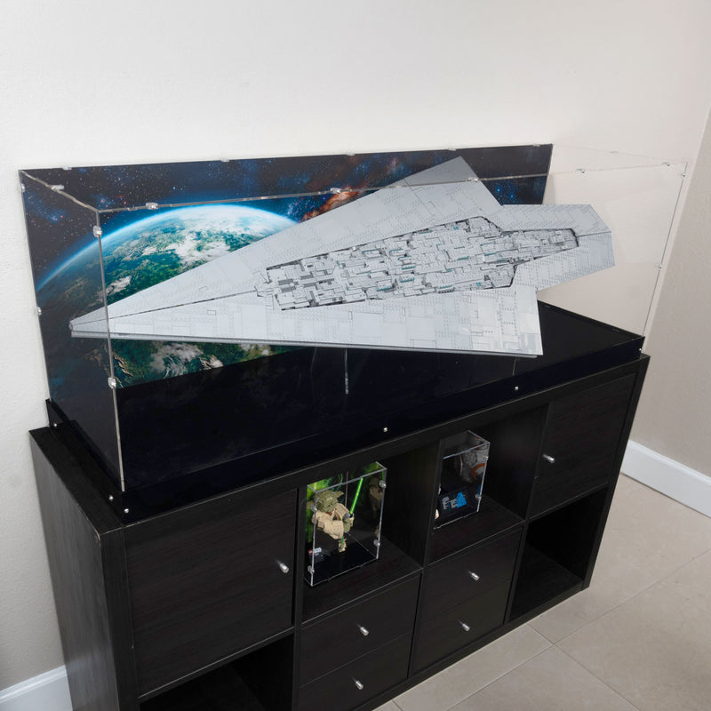 A large clear acrylic display case holding the lego star wars 75457 set, on top of a black storage cabinet in an indoor room with a mural showing Endor space.