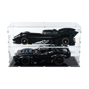 Two batmobile lego sets displayed inside a clear acrylic double-tiered display case on a black base
