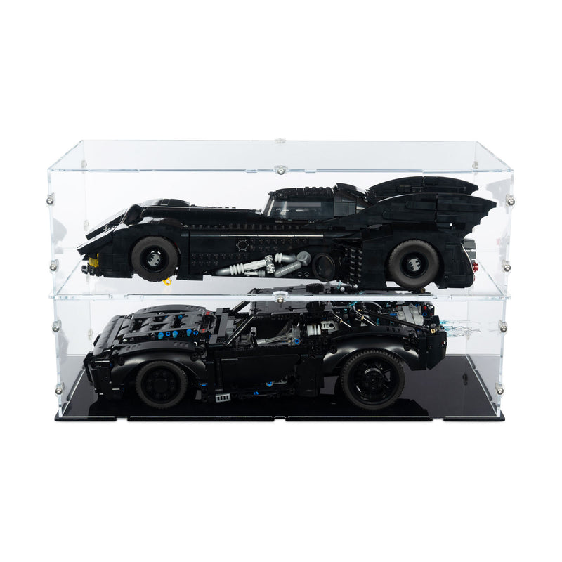 Two batmobile lego sets displayed inside a clear acrylic double-tiered display case on a black base