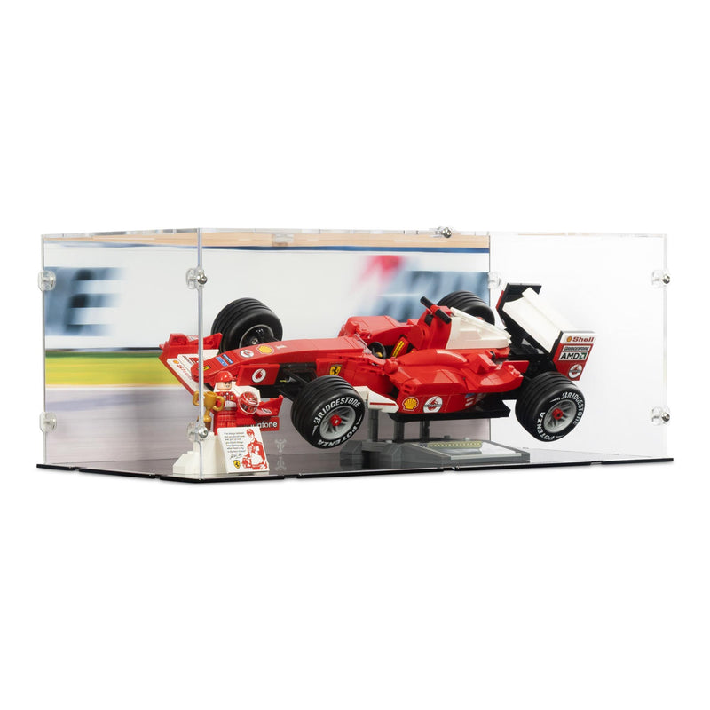 Model of a red LEGO Formula 1 car in a display case with a blurred racing background.