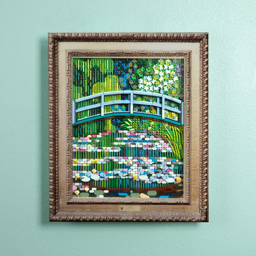 A framed art print depicting a lego Japanese garden scene with a blue arched bridge over water lilies, mounted with an acrylic wall frame.